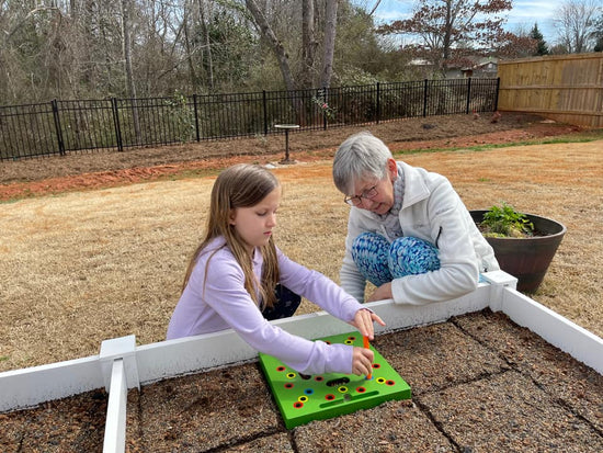 Seeding_Square_with_Carol_Annand_granddaughter
